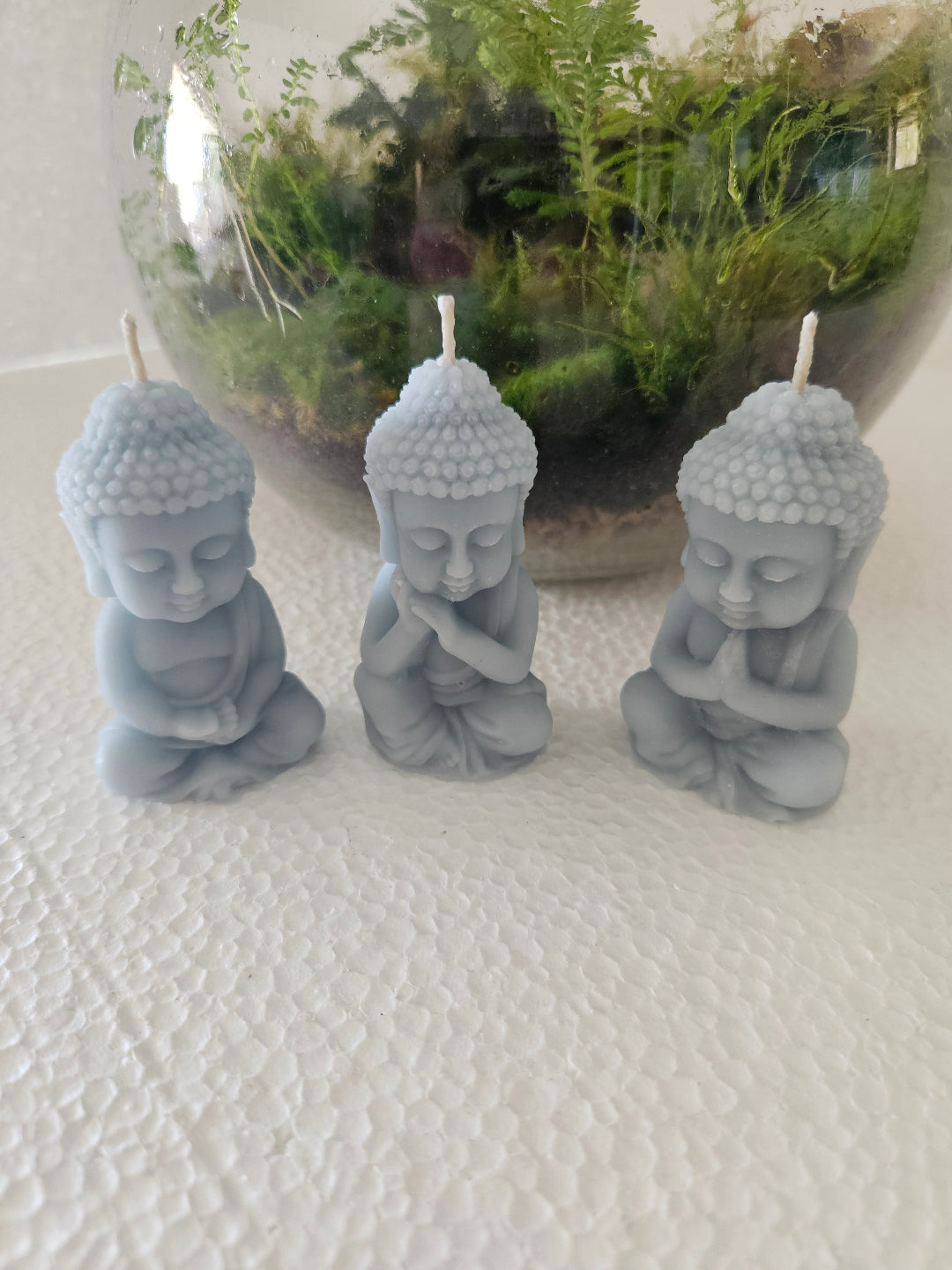 Praying baby Buddha candles